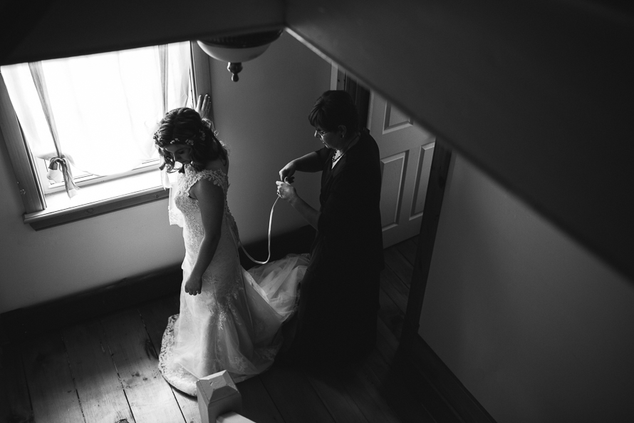 Mother of the bride helping bride get ready at Emilyville, Inn in Campbellford, Ontario