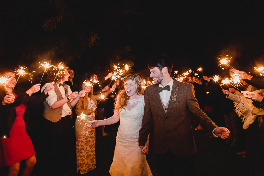 Bride and groom with guests and sparklers at Polmenna Barn wedding reception in Campbellford, Ontario