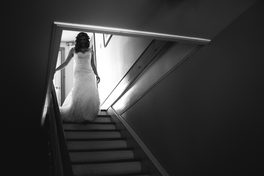 Bride descending staircase at Emilyville, Inn in Campbellford, Ontario